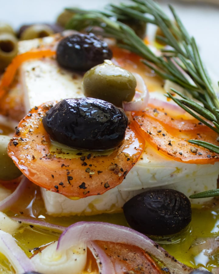 Baked Feta with olives, rosemary, tomato slices and red onions