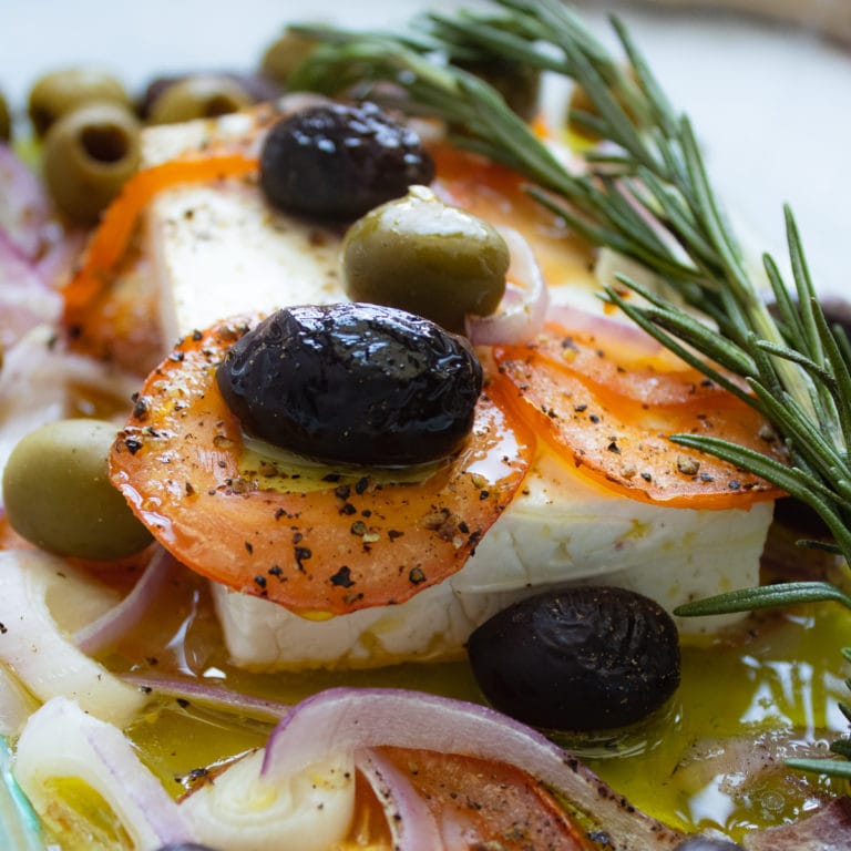Baked Feta with olives, rosemary, tomato slices and red onions