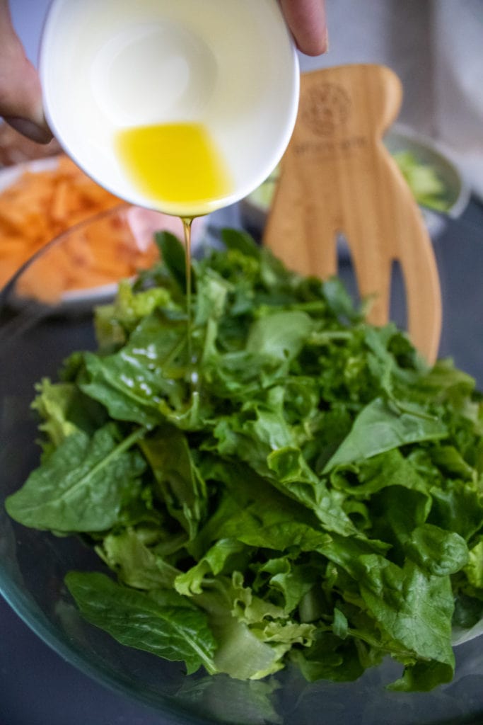 Step Instructions - pour olive oil onto the lettuce