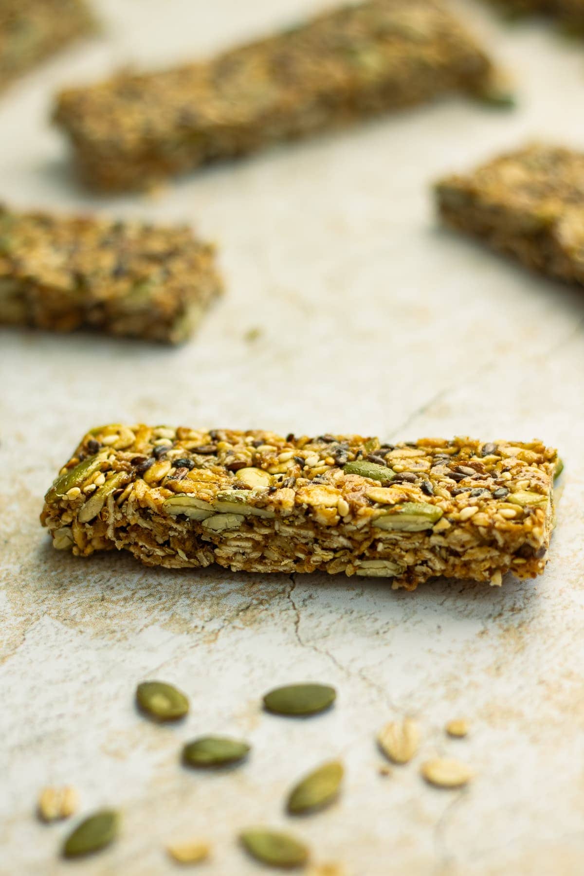 Granola bar in focus with multiple granola bars blurred out in the back
