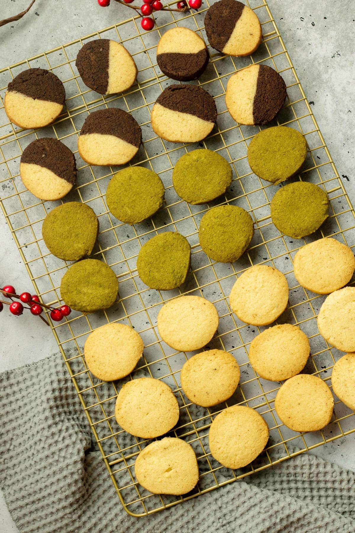Three types of German Heidesand Cookies - Matcha, Chocolate and Vanilla, as well as classic on a cooling rack.